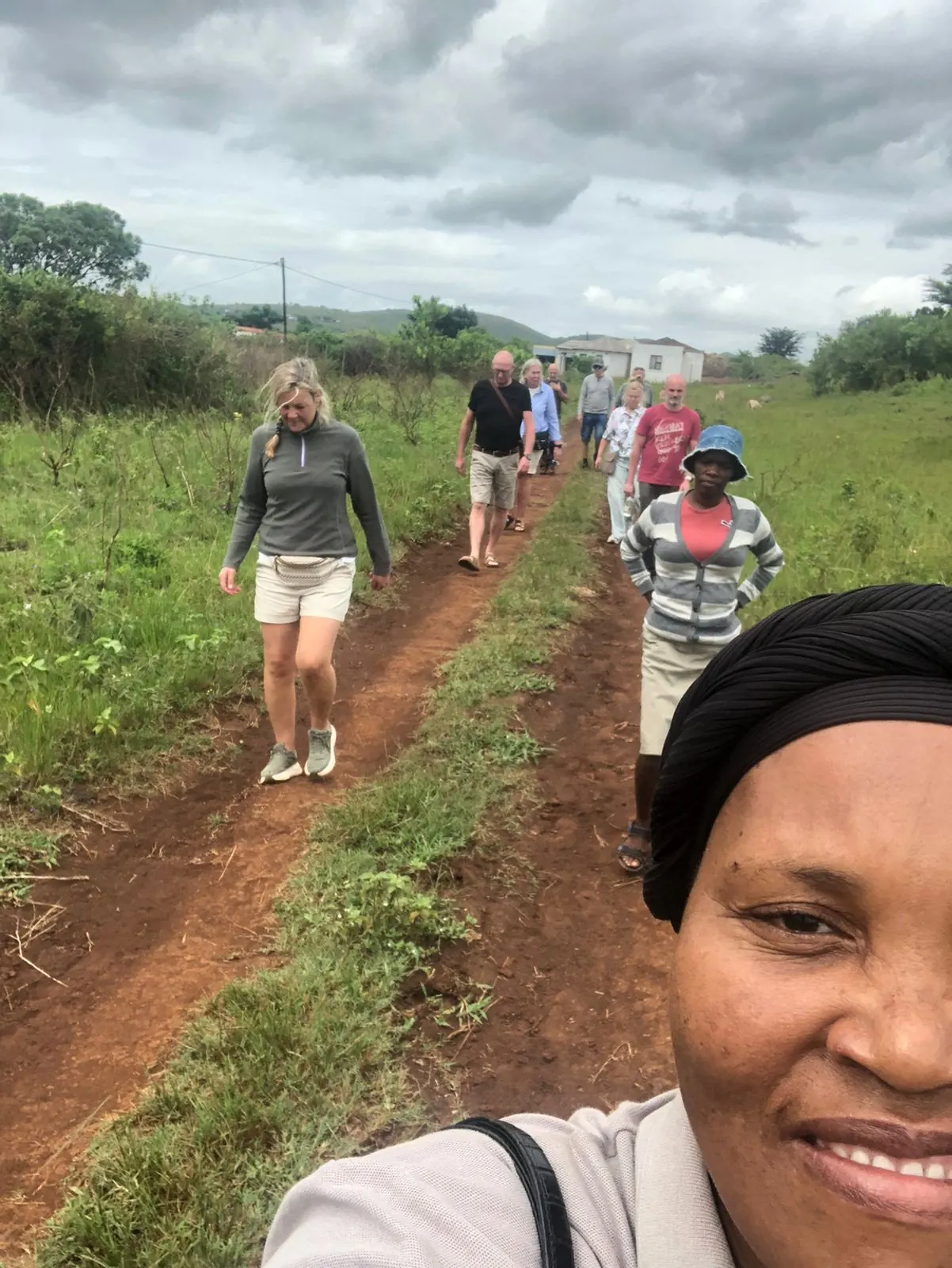 Khondlo Tours guide leading guests along a grassy village path