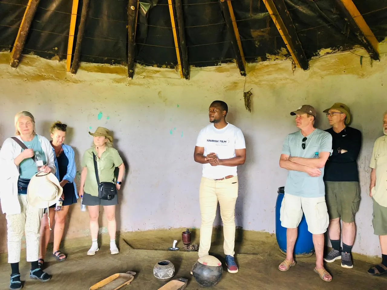 Guide explaining traditional items inside a rondavel