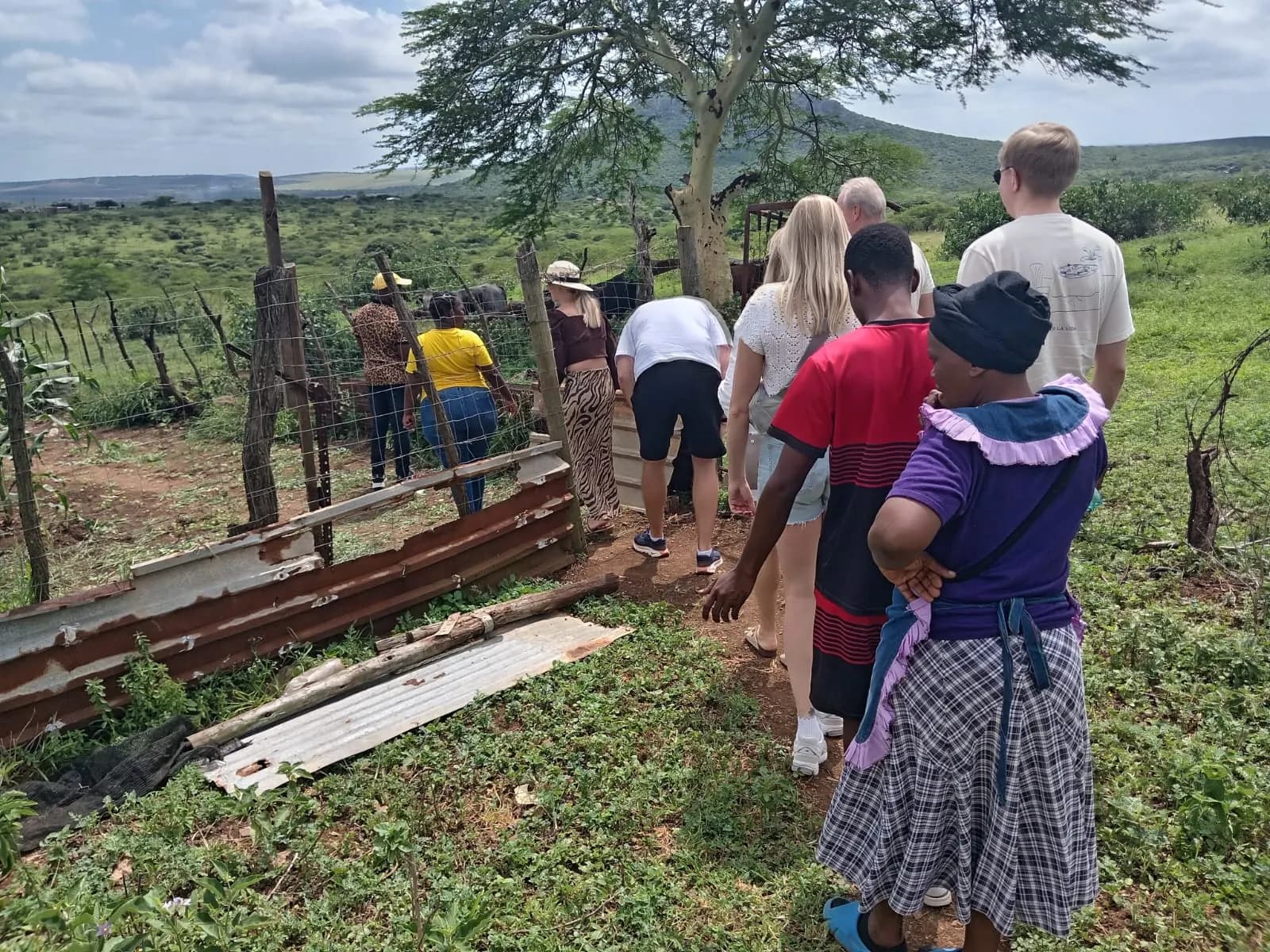 Village host welcoming guests at a homestead